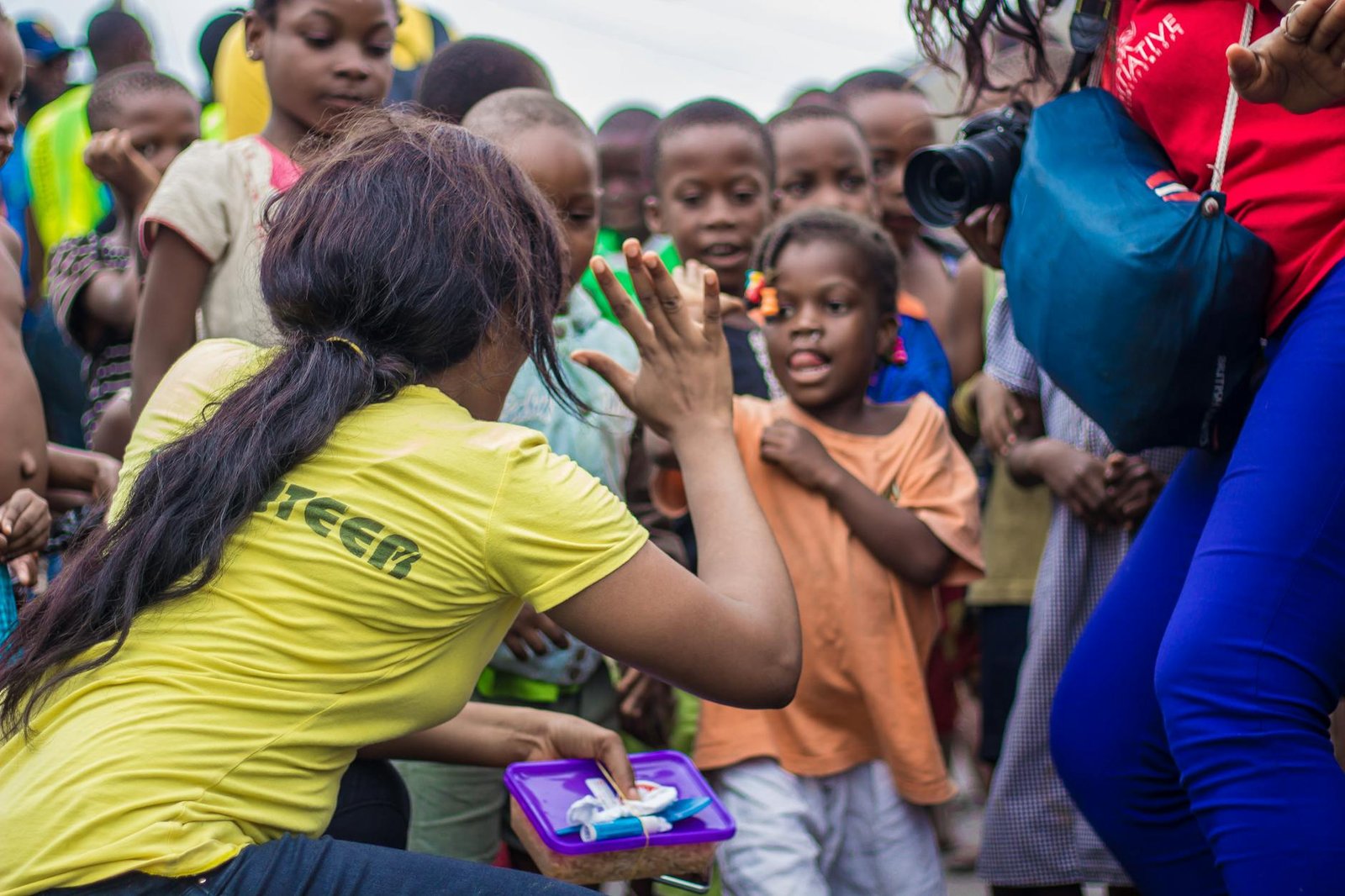 Volunteer engaging with children in community setting