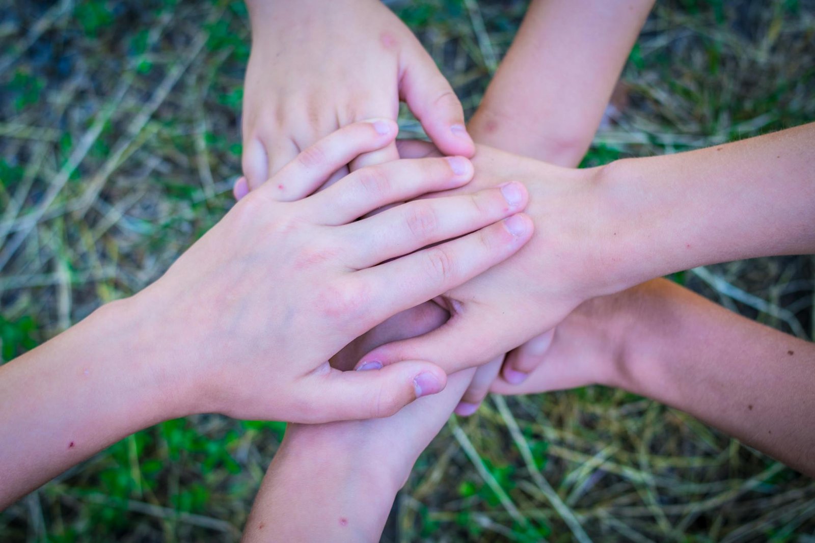 Diverse group joining hands in unity